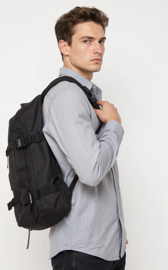 A French male model with a Duffel backpack, wearing a shirt, against a white background, in a front   facing close   up